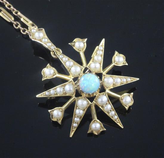 An Edwardian 15ct gold, white opal and split pearl starburst pendant on a later 9ct gold chain, pendant 28mm.